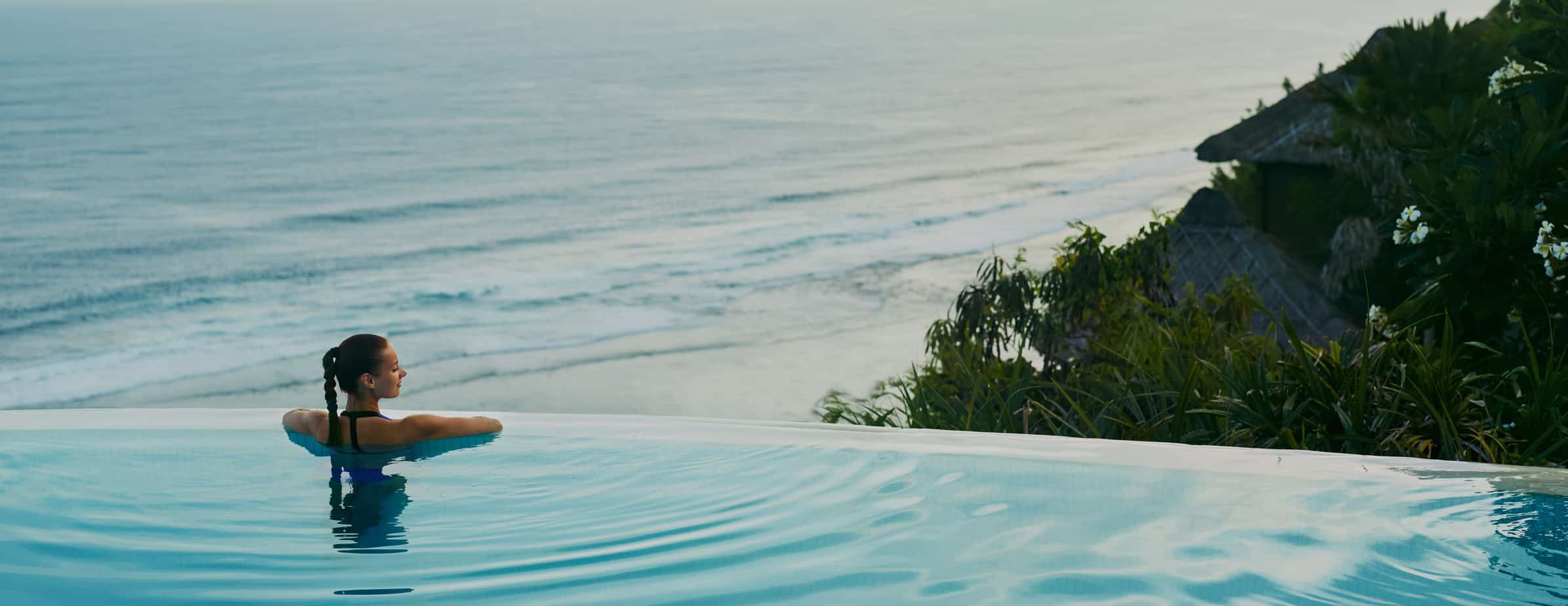 employee relaxing in the pool during a wellness vacation